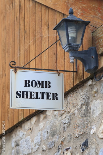 Bomb shelter sign on the wall in village of Beer in East Devon © Savo Ilic