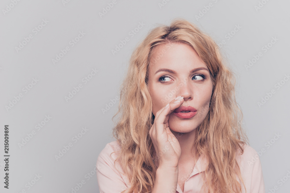 Young lovely attractive caucasian curly-haired cheerful charming gorgeous woman secret gossip girl. Isolated over grey background Young lovely attractive caucasian curly-haired cheerful charming gorgeous woman secret gossip girl. Isolated over grey background