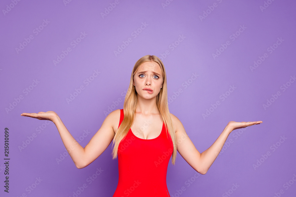 Attractive confused puzzled blonde gorgeous girl wearing red swim suit ...