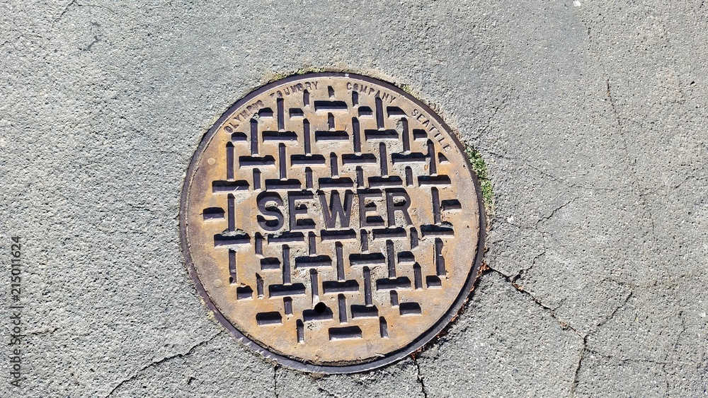 Sewer metal cap on the road in close up
