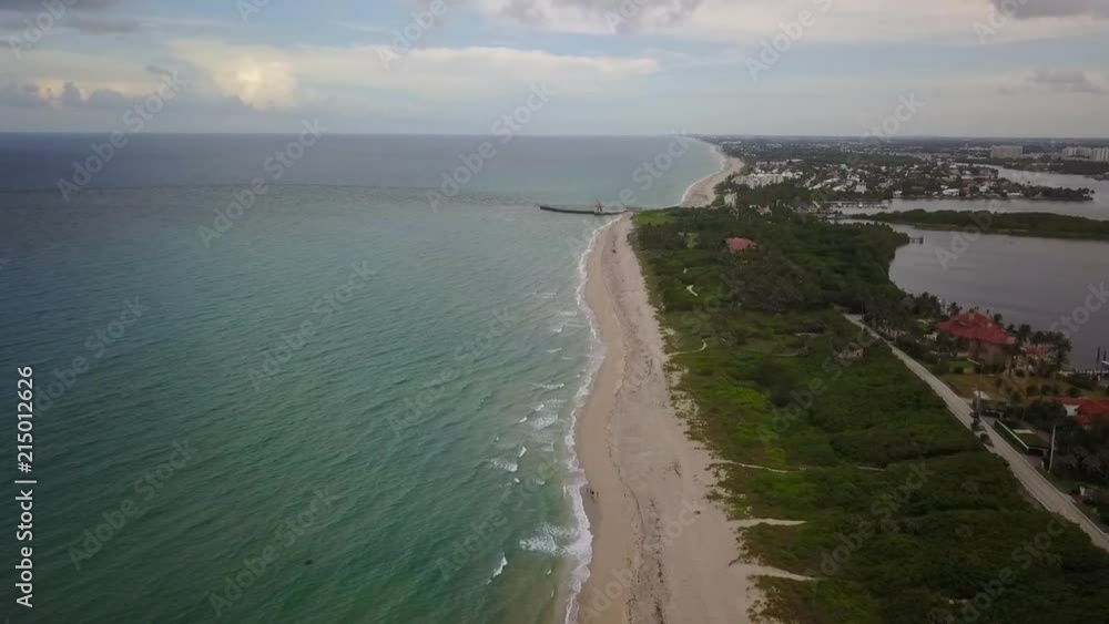 Dolly in over beach shore towards Boynton Beach Inlet Pier Dolly in over beach shore towards Boynton Beach Inlet Pier