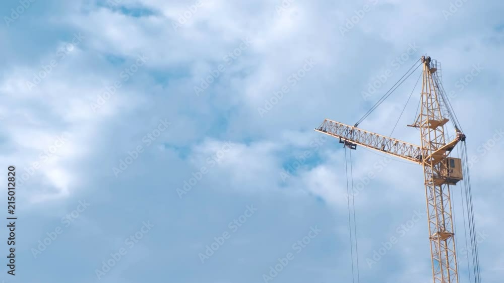 Construction of a multi-storey building. House and construction crane on sky background. Construction of a multi-storey building. House and construction crane on sky background.