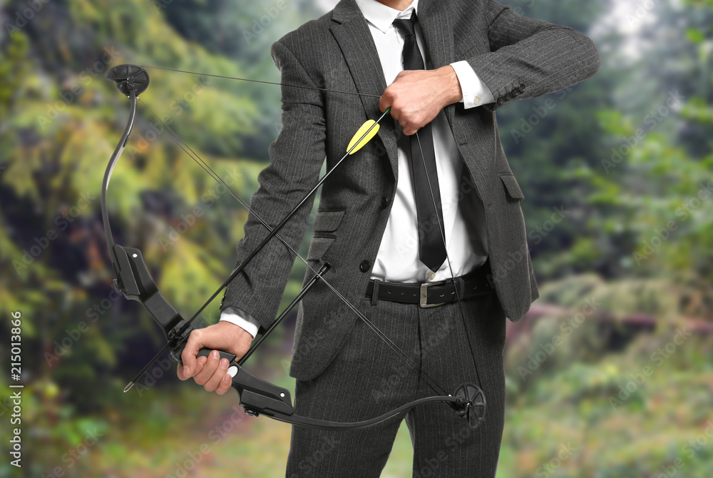 Businessman practicing archery on white background