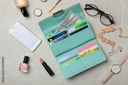 Flat lay composition with stylish wallet, smartphone and accessories on light background