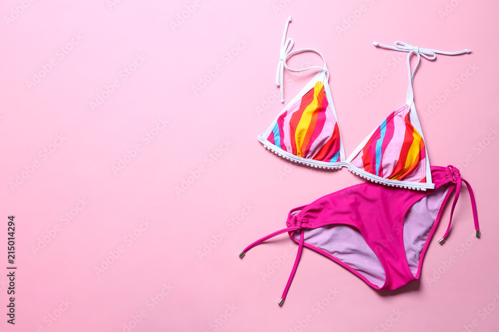 Naklejka premium Stylish bikini on color background, top view
