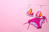 Stylish bikini on color background, top view