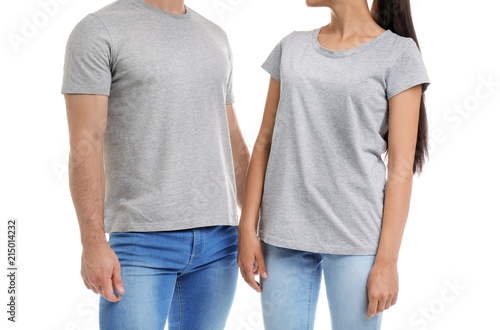 Young couple in t-shirts on white background. Mockup for design