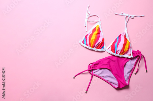 Stylish bikini on color background, top view