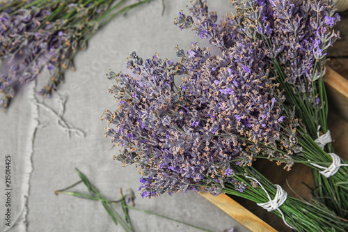 Fototapeta Naklejka Na Ścianę i Meble -  Wooden box with lavender flowers on table, top view