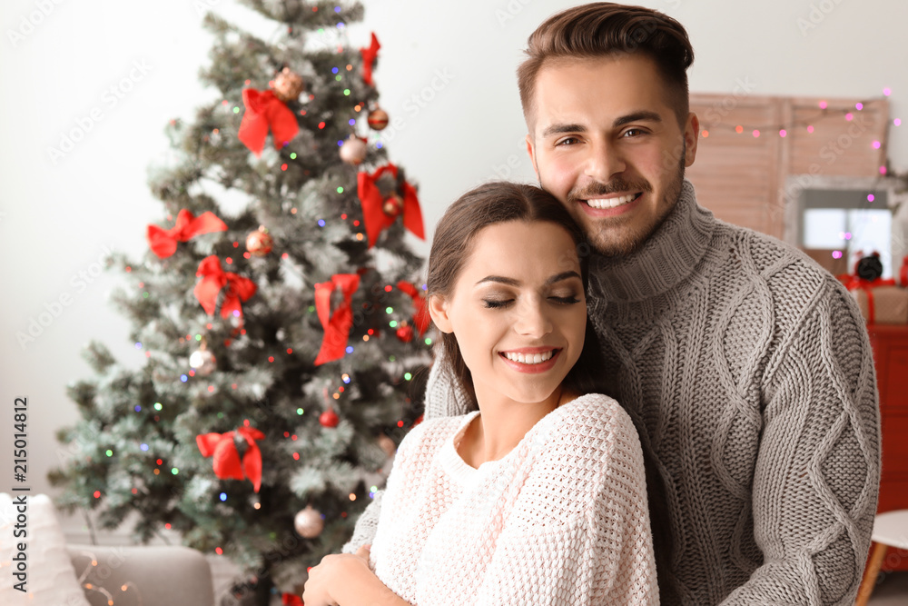 Happy young couple celebrating Christmas at home Happy young couple celebrating Christmas at home