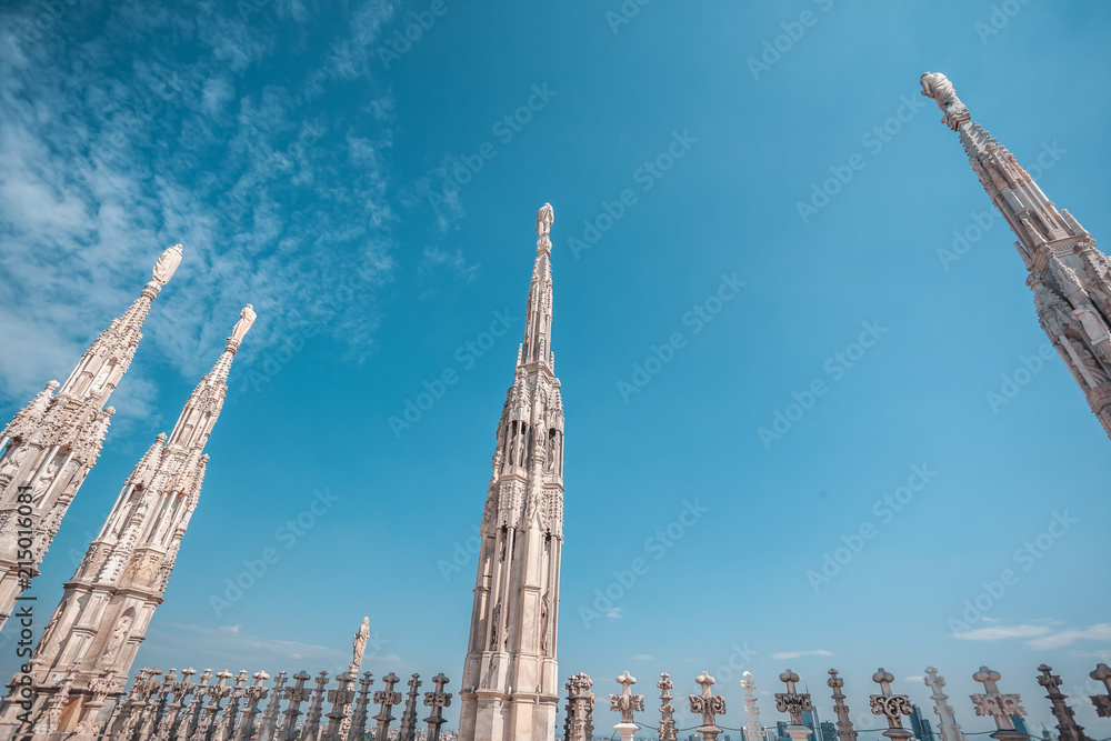 Fototapeta premium view of Gothic architecture and art on the roof of Milan Cathedral (Duomo di Milano), Italy