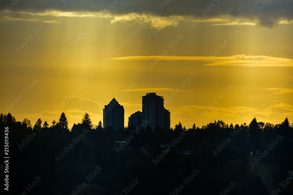 Residential towers silhouette on sunset sky background