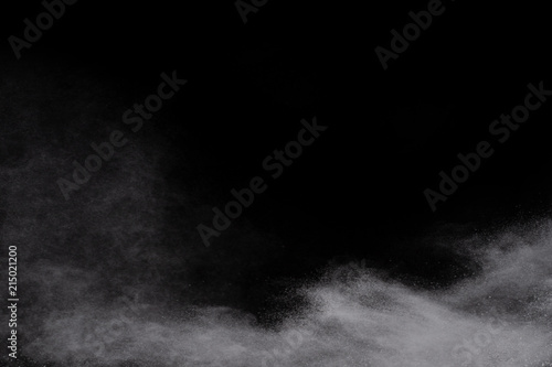 Launched white powder, isolated on black background. © kitsana