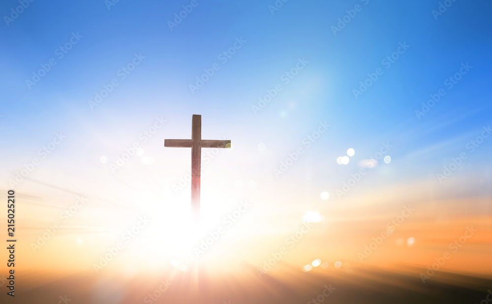 Cross on blurred sky background