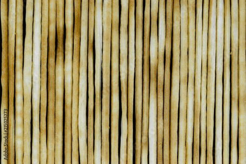 Group of baked italian bread sticks background on black background surface