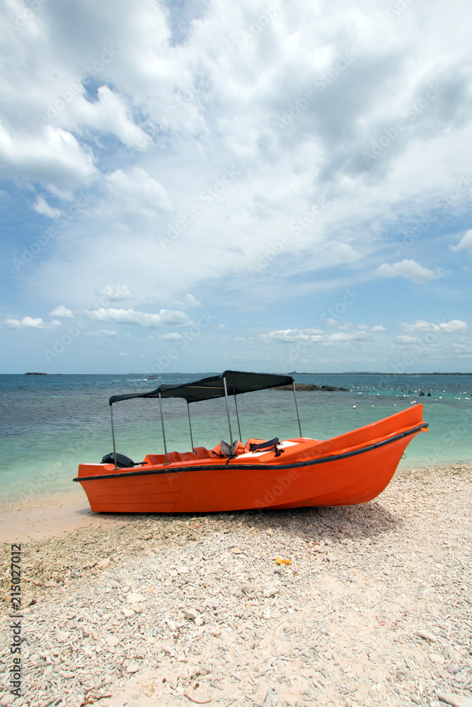 Orange panga / fishing boat on coral beach in Sri Lanka Asia