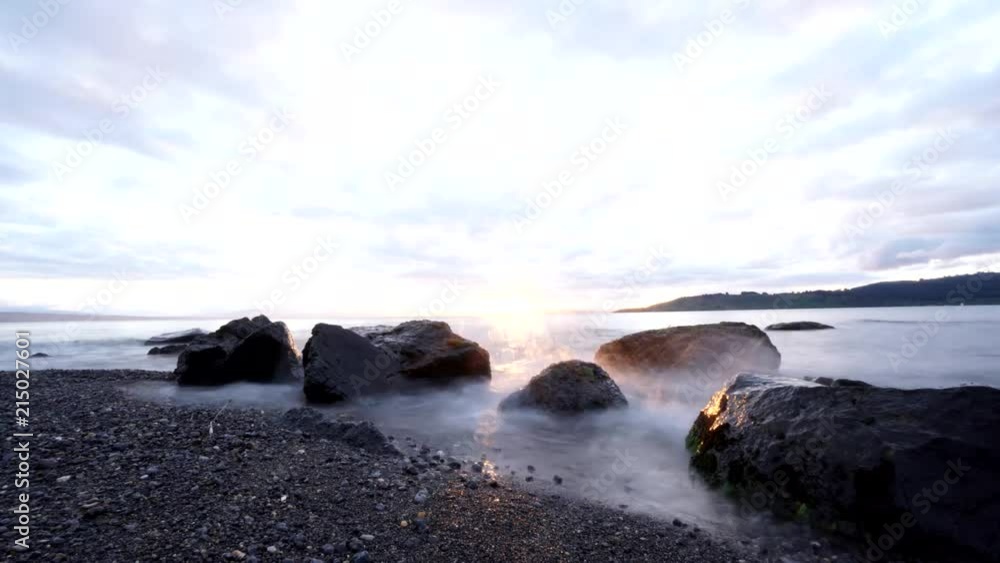 Sunset on a lake from the shore - Time lapse Sunset on a lake from the shore - Time lapse
