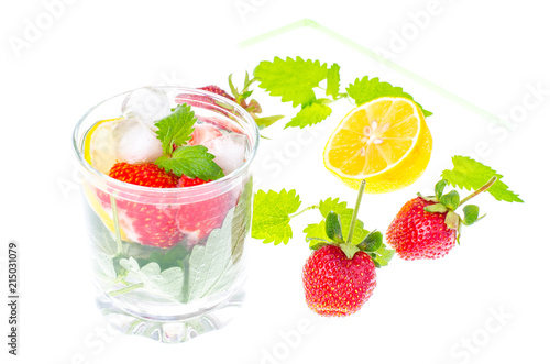 Cold summer drink with strawberries, lemon and mint