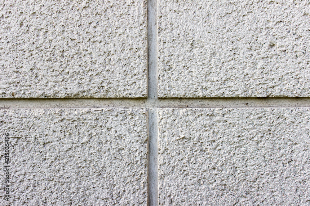 Fototapeta premium Texture of concrete wall with a cross in the center of image. Plaster texture with small holes.