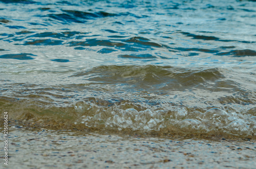 beach with sand near the water, on the shore of the lake