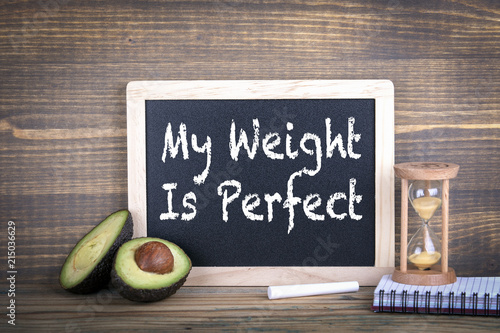 Fototapeta Naklejka Na Ścianę i Meble -  my weight is perfect. Fitness, healthy eating and veganism. Chalkboard on a wooden background