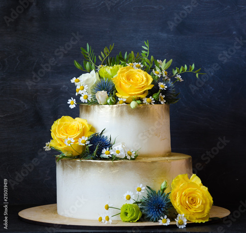 Two layered gilded wedding cake with flowers