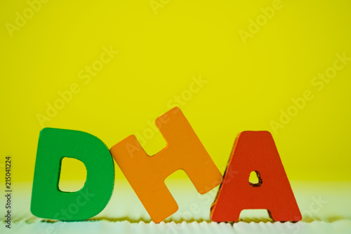 Konstfotografi DHA text alphabet on white wooden table