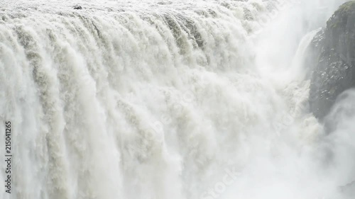 Iceland Dettifoss waterfall largest greatest volume in Europe closeup, gray grey water, rocky cliff and water flowing