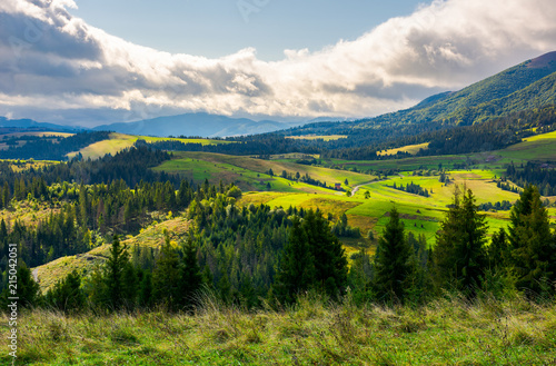 lovely rural area in mountains. huge cloud formation over the distant ridge. picturesque scenery of Carpathian alps