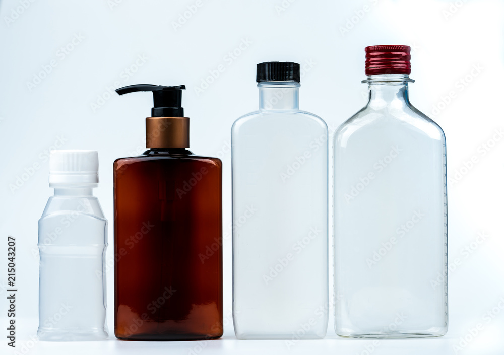 Empty plastic and glass bottle with cap and pump with black label isolated on white background. Pharmaceutical products bottle packaging. Empty plastic and glass bottle with cap and pump with black label isolated on white background. Pharmaceutical products bottle packaging.