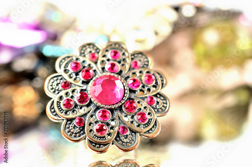 Brooch - richly decorated, red artificial stones - close-up
