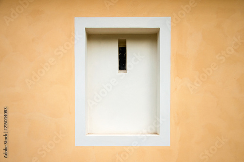White framed window recession in peach colored wall © hellame