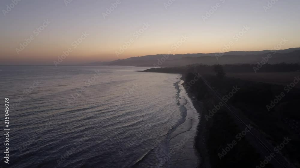 California coast sunset push in along the shoreline and ocean-side highway California coast sunset push in along the shoreline and ocean-side highway