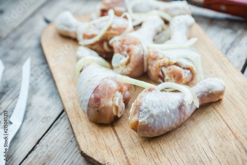 Raw chicken legs ready for grill. Selective focus.