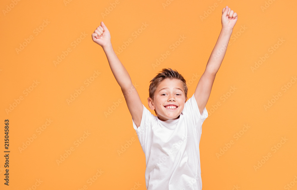 Little boy jumping in the studio, smiling. Little boy jumping in the studio, smiling.
