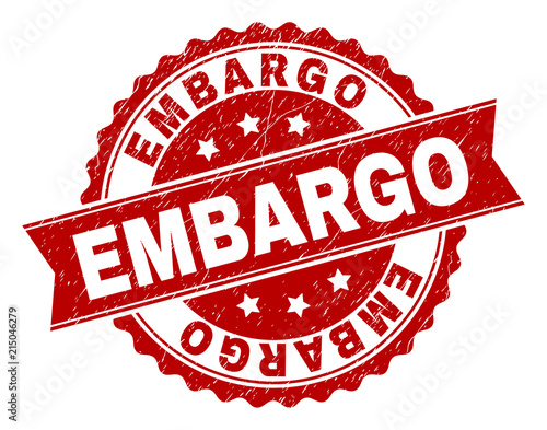EMBARGO seal print with distress style. Rubber seal imitation has round medallion form and contains ribbon. Red vector rubber print of EMBARGO text with dirty texture.