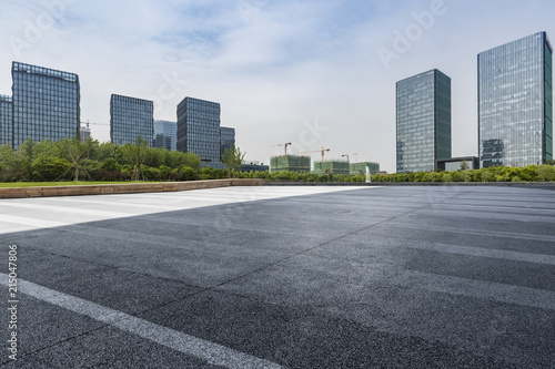 Panoramic skyline and modern business office buildings with empty road empty concrete square floor