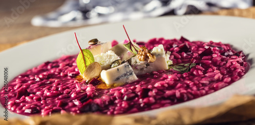 Plate of tasty beetroot risotto with cheese and aperitif