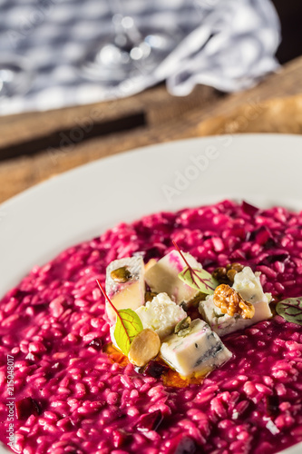 Plate of tasty beetroot risotto with cheese and aperitif