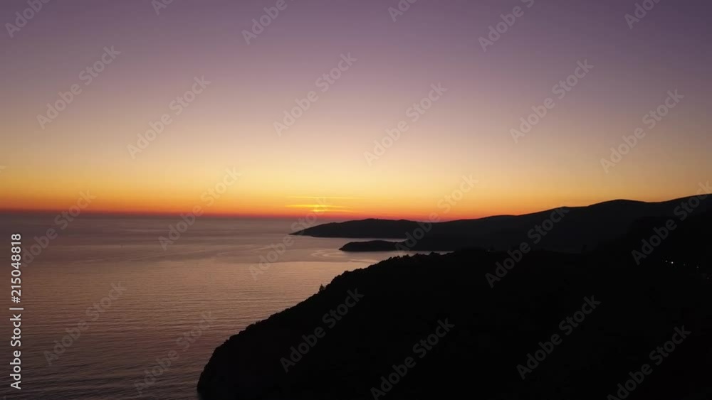Aerial view of mountain silhuettes in a very colorful sunset outsite the town of Budva, Montenegro. Aerial view of mountain silhuettes in a very colorful sunset outsite the town of Budva, Montenegro.