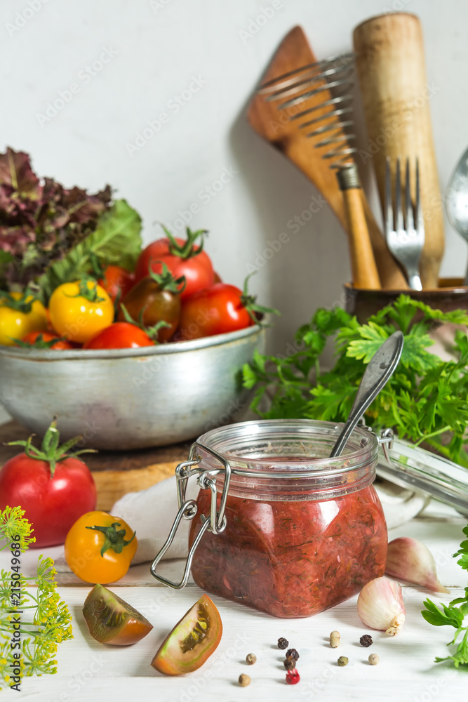 Tomato sauce and fresh tomatoes, garlic, dill, parsley on a light wooden background still life in vintage rustic style Tomato sauce and fresh tomatoes, garlic, dill, parsley on a light wooden background still life in vintage rustic style