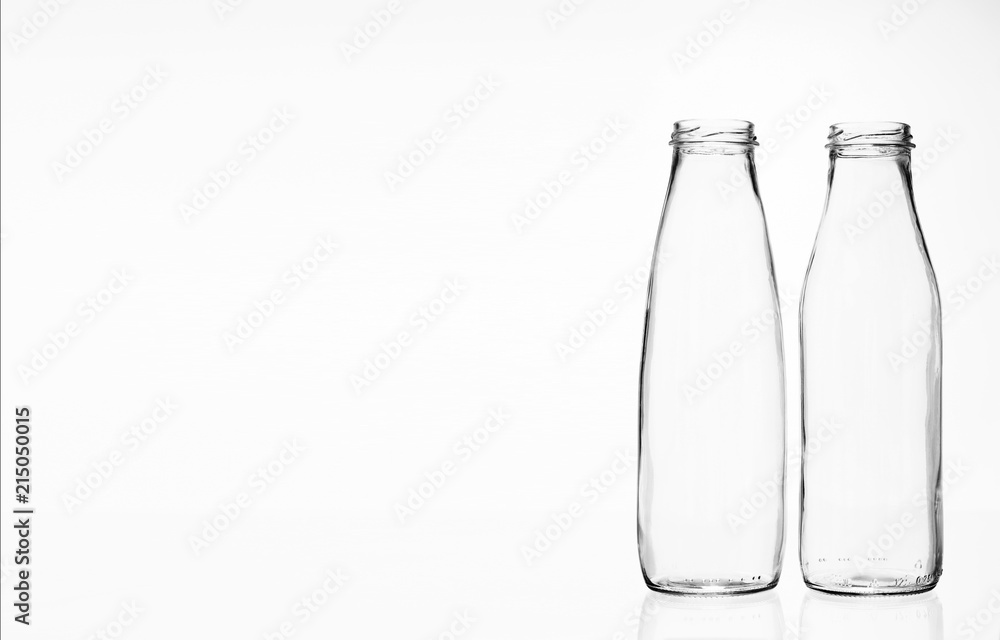 Two empty milk or kefir bottles of different shapes with copy space