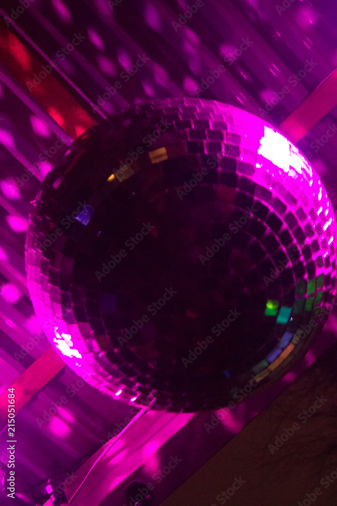 Wallpaper background of sparkling disco ball illuminated by a pink laser  light at a party. No people. Stock Photo | Adobe Stock