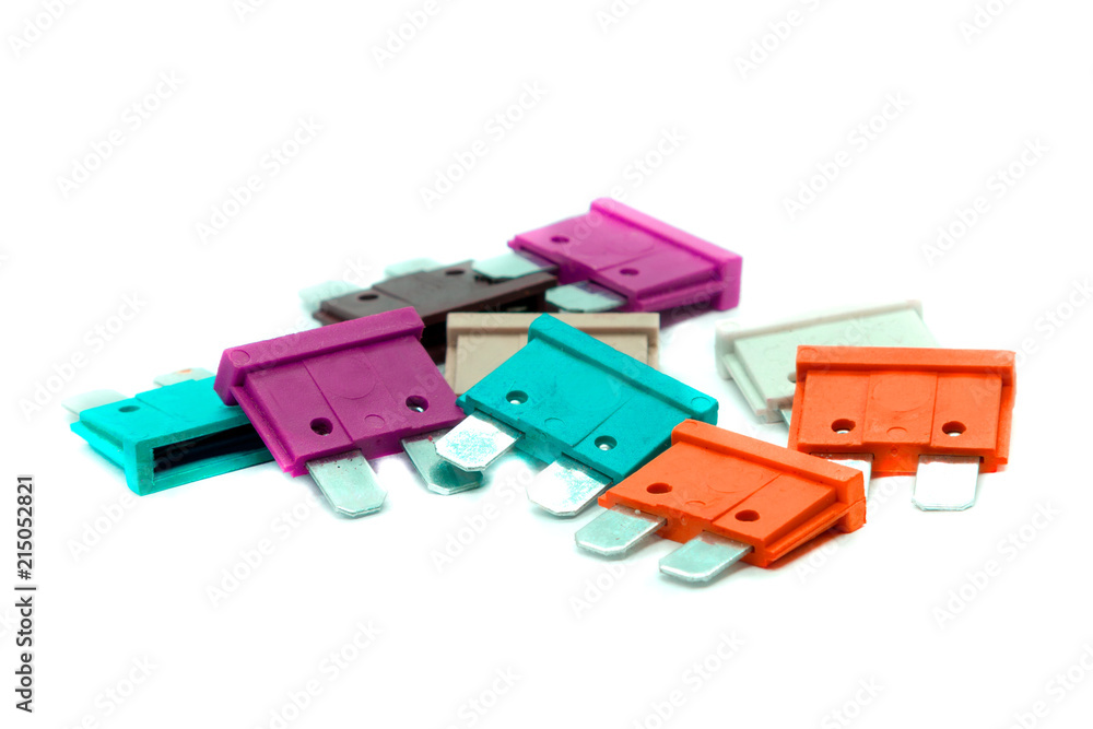 Obraz premium Several multi-colored car fuses for the fuse box. Replacing the electric fuses in the car. Isolate on white background.