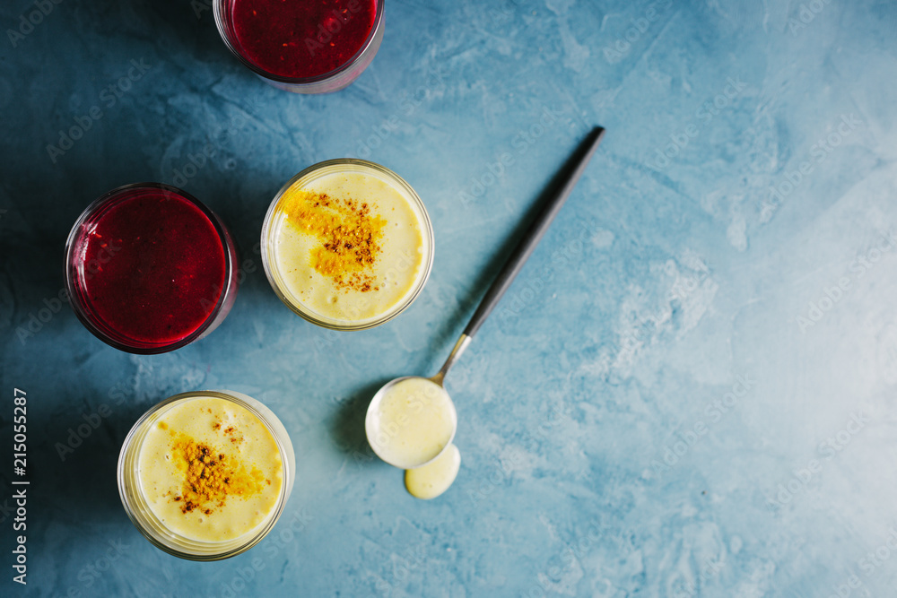 Golden yogurt milk with turmeric and red smoothie Golden yogurt milk with turmeric and red smoothie