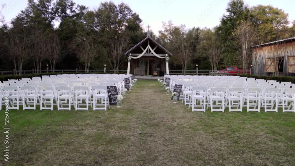 At an outdoor wedding venue positioned next to a Barn. At an outdoor wedding venue positioned next to a Barn.