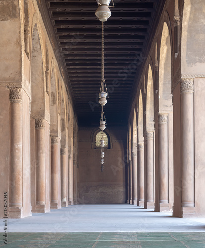 Corridor at the courtyard of the Mosque of Ahmad Ibn Tulun framed by huge decorated arches, old Cairo, Egypt photo