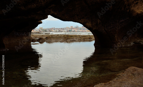 Hole on the rock and city view during low tide  Las Palmas de Gran Canaria  Canary islands