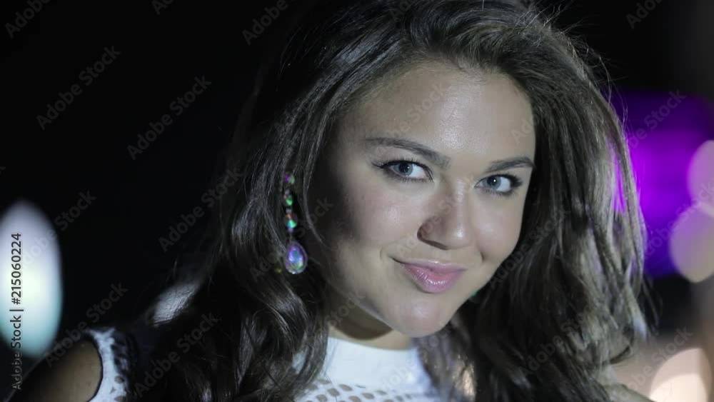 Closeup attractive luxury woman with earrings turn face at night Closeup attractive luxury woman with earrings turn face at night