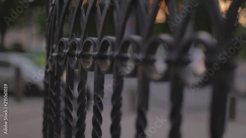 close up focuss pull of a hand rail in the middle of a buisy city photo